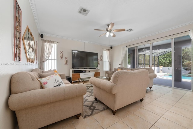 living room with ceiling fan, light tile patterned floors, and crown molding