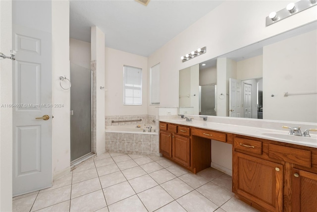 bathroom with tile patterned flooring, vanity, and separate shower and tub