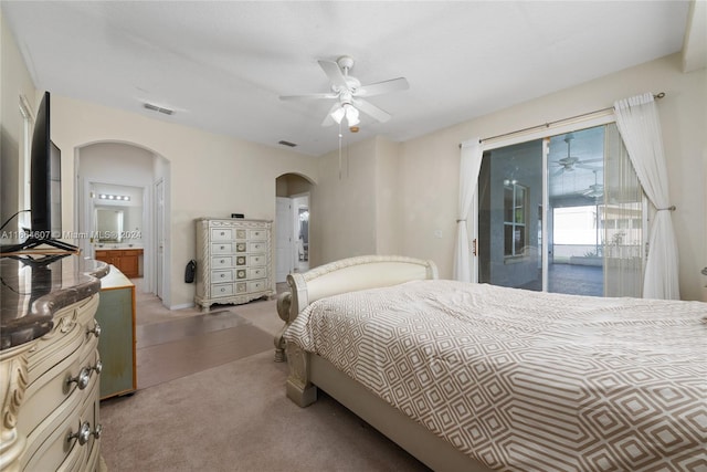 bedroom with access to outside, connected bathroom, carpet flooring, and ceiling fan