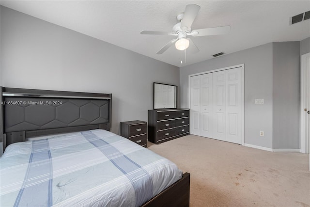 carpeted bedroom with a closet and ceiling fan