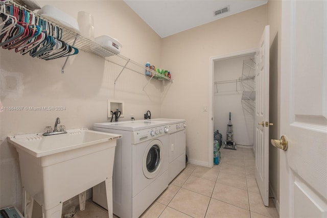 laundry room with light tile patterned floors, sink, and washer and dryer