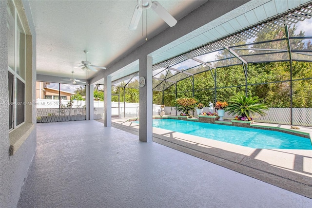 view of pool featuring ceiling fan, a lanai, and a patio