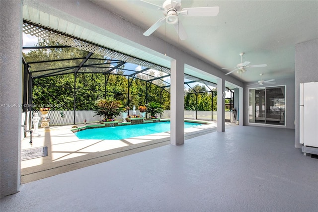 view of swimming pool with ceiling fan, glass enclosure, and a patio