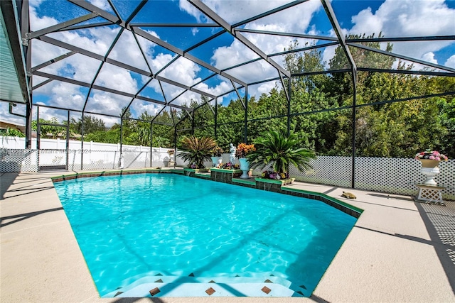 view of pool featuring a patio and glass enclosure