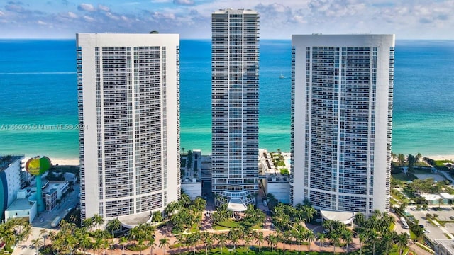 bird's eye view with a water view and a beach view