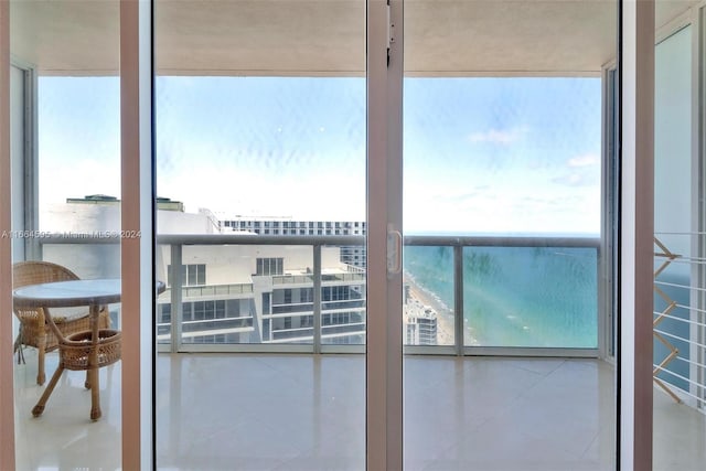 interior space with a view of the beach and a water view