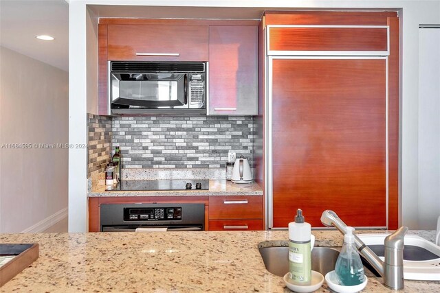 1830 S Ocean Dr Unit 4709, Hallandale Beach, FL 33009 - kitchen with black appliances, decorative backsplash, and light stone countertops