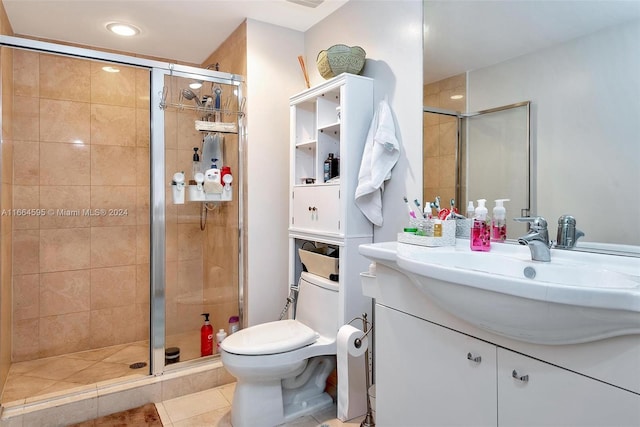 bathroom featuring walk in shower, tile patterned flooring, vanity, and toilet