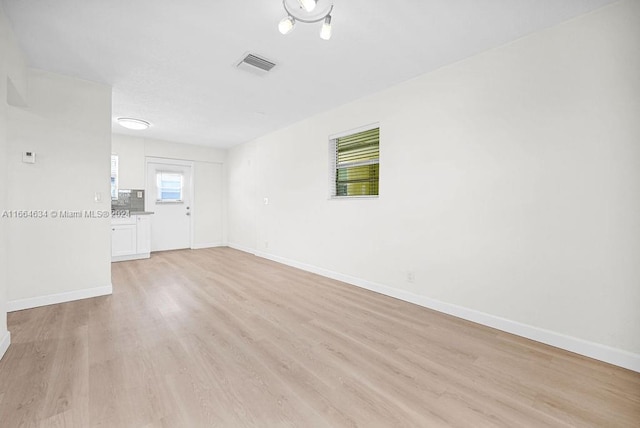 unfurnished room with light hardwood / wood-style flooring