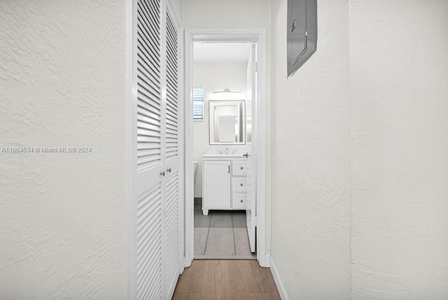 hall featuring electric panel and hardwood / wood-style flooring