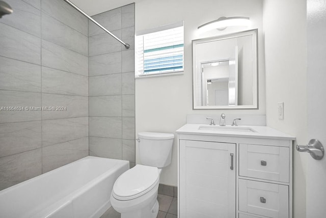 full bathroom with tiled shower / bath, vanity, toilet, and tile patterned floors