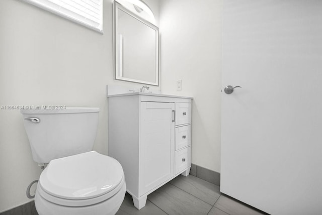 bathroom with vanity, toilet, and tile patterned floors