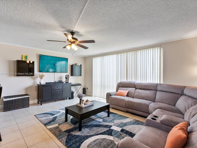 tiled living room with ceiling fan, a textured ceiling, plenty of natural light, and crown molding