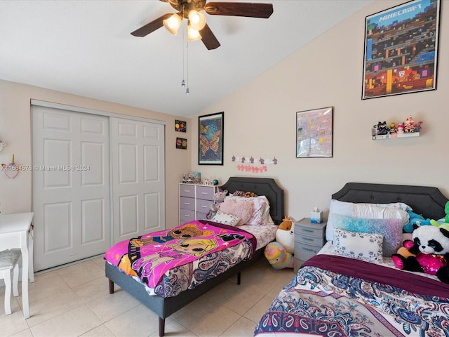 bedroom featuring a closet, vaulted ceiling, ceiling fan, and light tile patterned floors