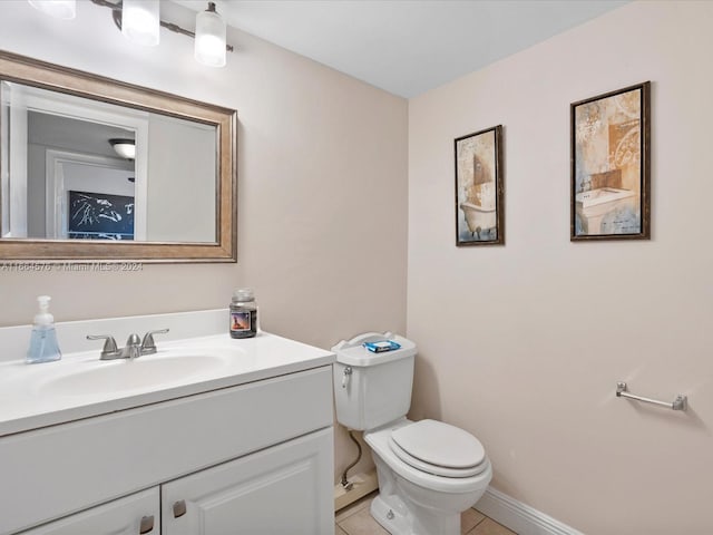 bathroom with vanity, toilet, and tile patterned floors