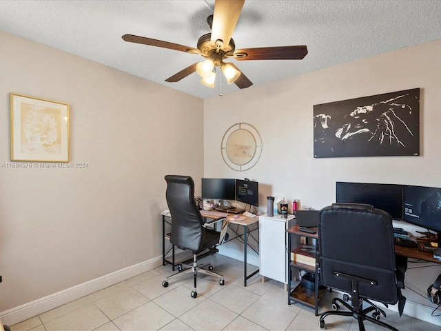 tiled home office with ceiling fan and a textured ceiling