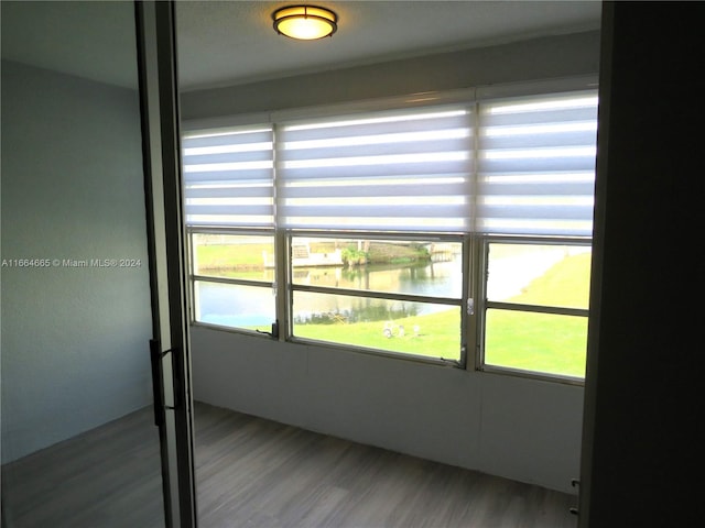 interior space with a water view and hardwood / wood-style flooring