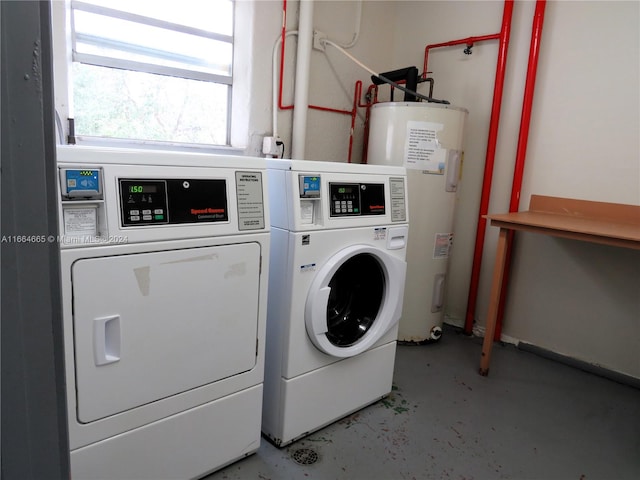 clothes washing area with water heater and washing machine and dryer