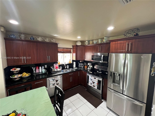 kitchen featuring sink, light tile patterned floors, and appliances with stainless steel finishes