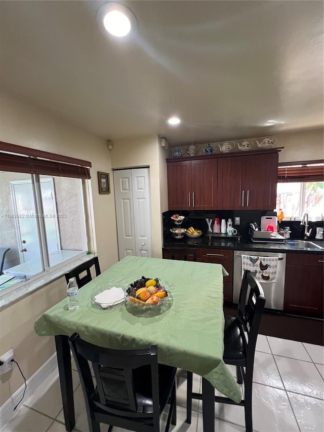 kitchen featuring dishwasher, light tile patterned floors, and sink