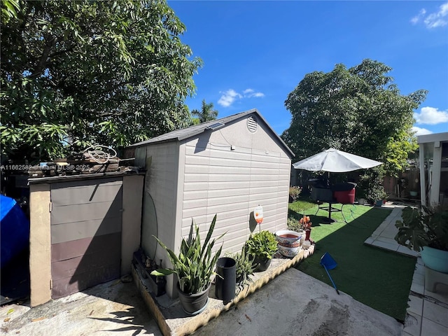 view of side of property featuring a storage shed and a yard