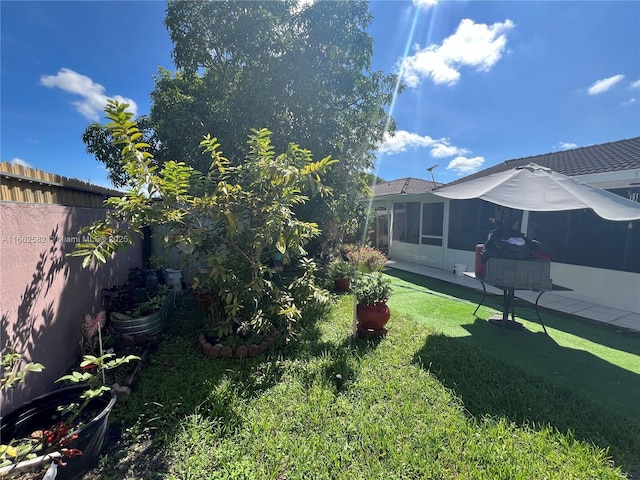 view of yard with a sunroom