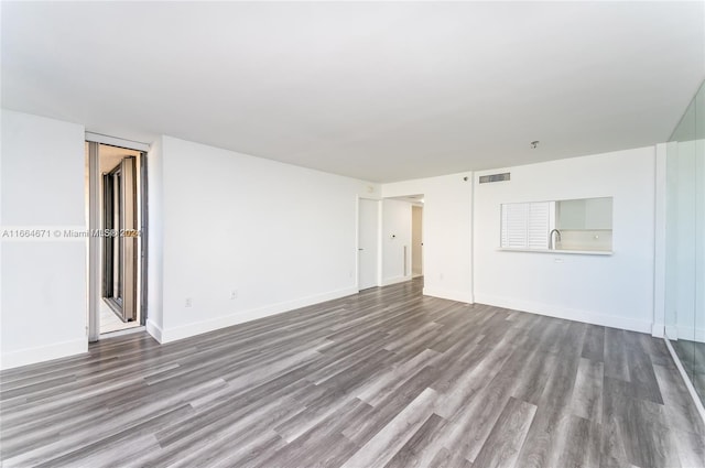 spare room with hardwood / wood-style floors