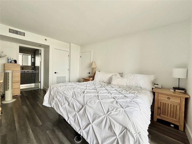 bedroom with dark hardwood / wood-style floors