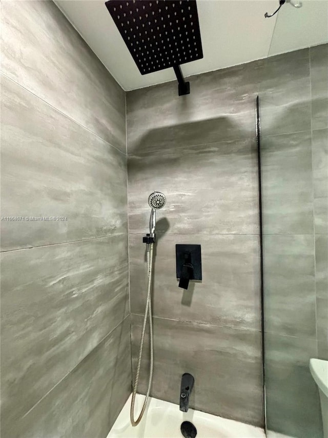 bathroom with tiled shower