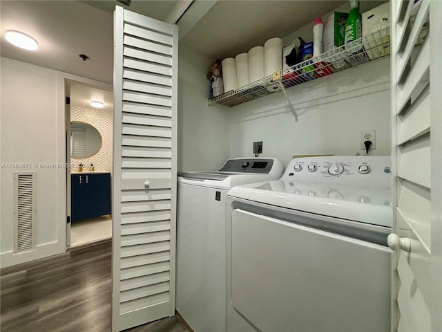 laundry room featuring washing machine and dryer and dark wood-type flooring