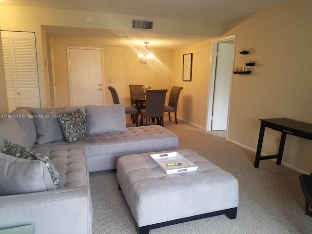 living room with carpet flooring and an inviting chandelier