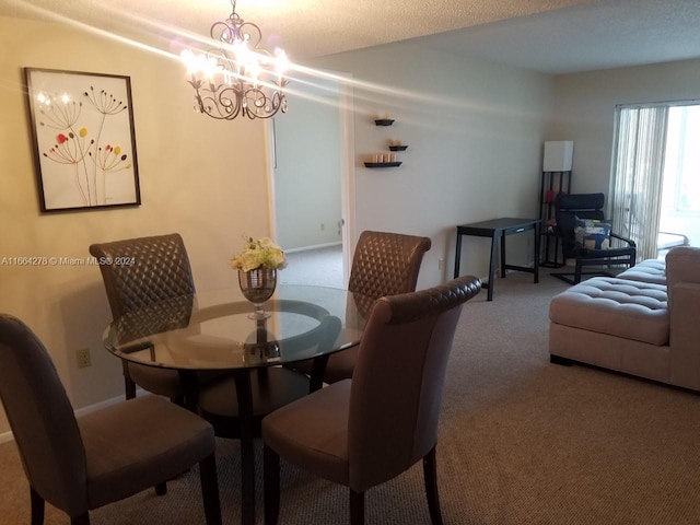 carpeted dining room with a textured ceiling and an inviting chandelier