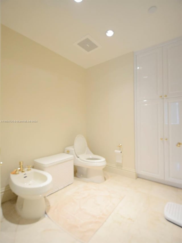 bathroom featuring toilet and a bidet