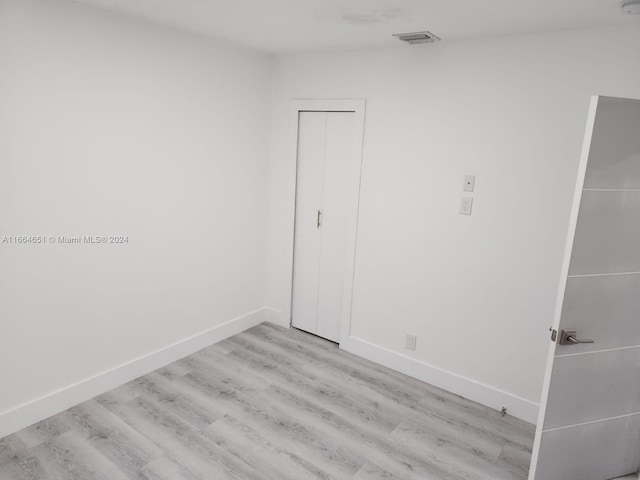 spare room with light wood-type flooring