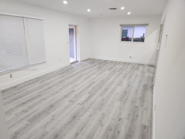 spare room with light hardwood / wood-style flooring