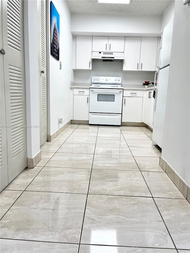 kitchen featuring white cabinets, a textured ceiling, and white appliances