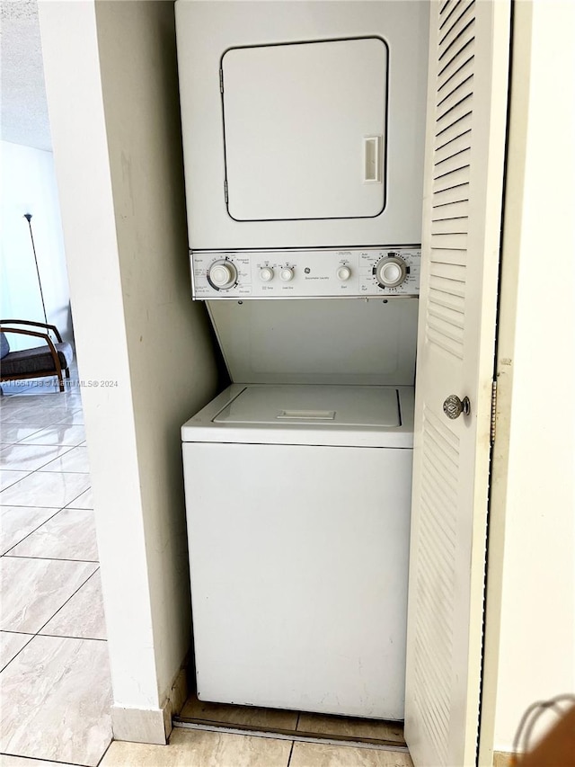 clothes washing area with stacked washer and clothes dryer