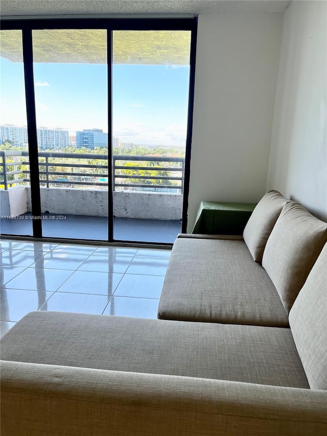 tiled living room featuring a wall of windows and plenty of natural light