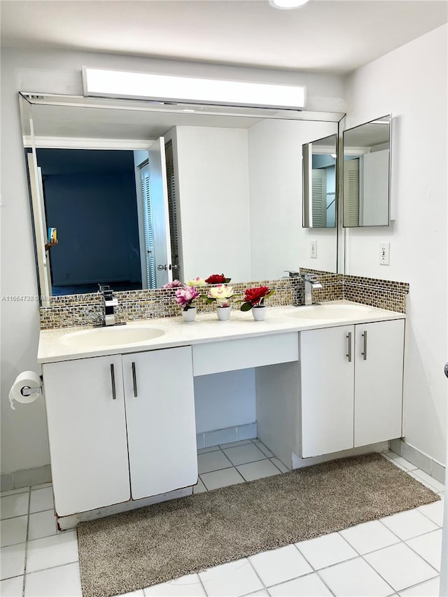 bathroom with tile patterned floors, vanity, and tasteful backsplash