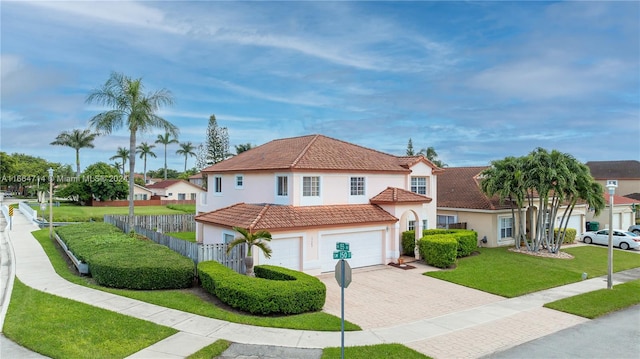 view of front of property featuring a front yard and a garage