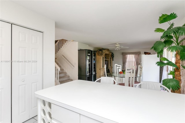 kitchen featuring white cabinets, ceiling fan, and stainless steel fridge