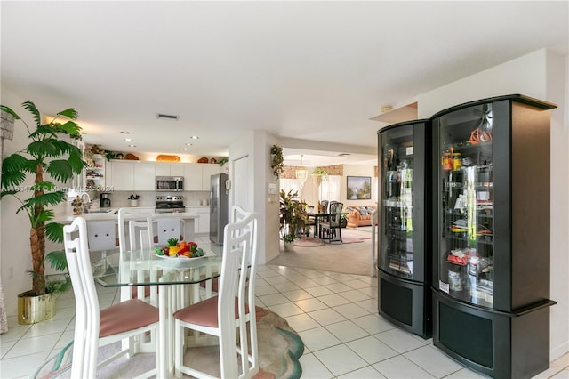 dining space with light tile patterned floors and sink