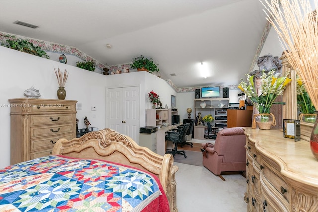 bedroom featuring light carpet, a closet, and vaulted ceiling