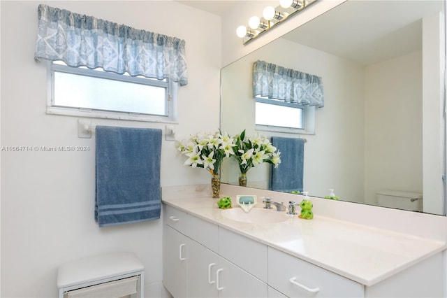 bathroom featuring vanity and toilet