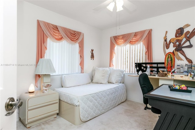 bedroom with ceiling fan and light colored carpet