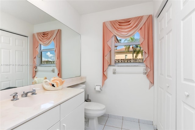 bathroom featuring vanity, tile patterned flooring, and toilet