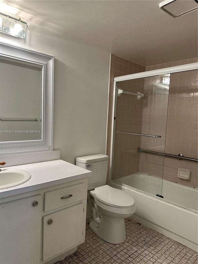 full bathroom with tile patterned flooring, vanity, toilet, and enclosed tub / shower combo