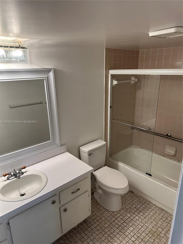 full bathroom with vanity, toilet, and bath / shower combo with glass door