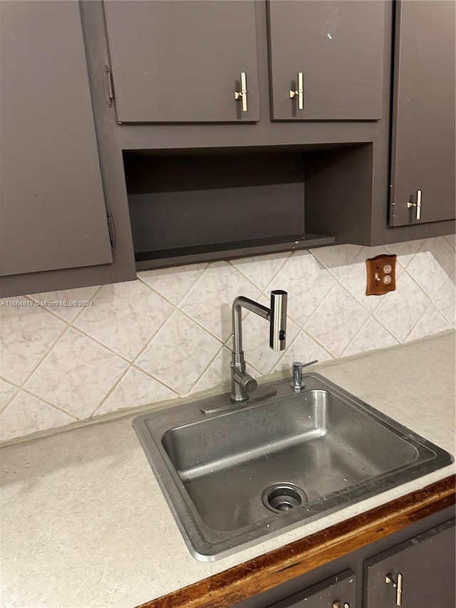 kitchen featuring tasteful backsplash and sink