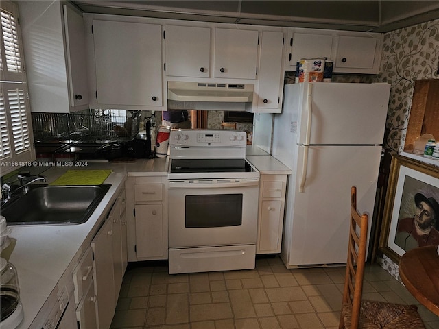 kitchen with white appliances, white cabinetry, and sink